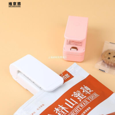Máy đóng thùng mini kiểu Nhật di động ma thuật kẹp đóng thùng hộ gia đình hạt đồ ăn nhẹ hút chân không đóng thùng nhỏ